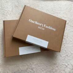 two boxes sitting on top of each other with one story fashion written on the front