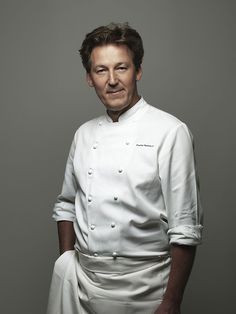 a man in a chef's outfit posing for a photo