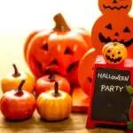 pumpkins and jack - o'- lanterns are sitting on a table with a sign that says halloween party