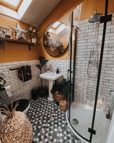 a bathroom with orange walls and black and white tile flooring is pictured in this image