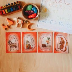 children's artwork displayed on wooden table with colored crayons