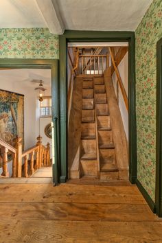 an open door leading to a wooden staircase