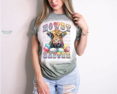 Howdy Easter Bleached Tee Introducing our Howdy Easter Bleached Tee, a must-have for Easter enthusiasts who adore cows! Crafted for comfort, this tee boasts a soft, lightweight feel with a unisex fit, available in sizes Small through 2X. Choose from a variety of vibrant shirt colors to suit your style. Soft style feel for luxurious comfort Light and breathable for all-day wearability Unisex fit ensures versatility for everyone Sizes ranging from Small to 2X accommodate diverse body types A spect Casual Cow Print T-shirt For Fall, Casual Fall T-shirt With Cow Print, Spring Cow Print Short Sleeve Top, Spring Cow Print Cotton Top, Spring Cotton Cow Print Top, Casual Cow Print Tops For Fall, Casual Cow Print Tops For Spring, Casual Spring Tops With Cow Print, Spring Casual Cow Print Tops