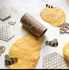 a paper roll sitting on top of a table next to bees and honeycombs