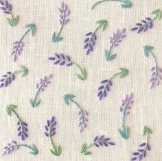 embroidered lavender flowers and leaves on white linen