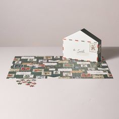 a piece of paper that has been cut out to look like a house on the ground