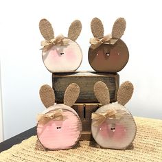 three wooden rabbits sitting on top of each other