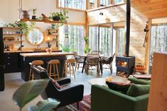 a living room filled with furniture and a fire place in the middle of a kitchen