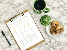 a clipboard with some food on it next to a cup of coffee