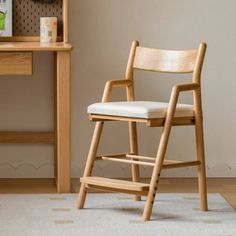 a wooden chair sitting on top of a white rug