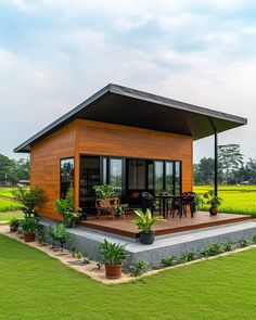 a small house sitting on top of a lush green field