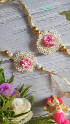 some beads and flowers on a table