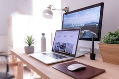 an open laptop computer sitting on top of a wooden desk