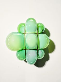 a green object sitting on top of a white surface