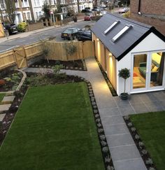 a small house is lit up in the evening