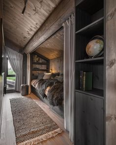 a bed room with a neatly made bed next to a book shelf and a window