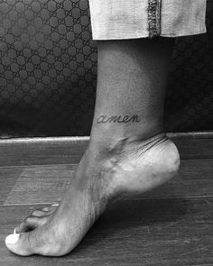 a person with a tattoo on their foot that says,'i amen '