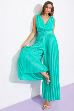 This stylish jumpsuit is the perfect addition for any spring wardrobe. It is made from a solid woven fabric and features a surplice neckline, sleeveless construction, and pleated pants for a flattering silhouette. An elasticized waist and self-tie belt provide a comfortable, adjustable fit. The surplice back adds a touch of elegance to your look. Details Self: 100% Polyester Lining: 100% Polyester Size & Fit - Model is 5`8 " And Wearing Size Small - Measurements Taken From Size Small - Approx. Length: 60” Stylish Jumpsuit, Kimono Sweater, Surplice Neckline, Luck Charm, Luck Charms, Pleated Pants, Spring Wardrobe, Sweater Coats, Tie Belt