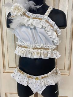 Sz 5 gorgeous off white and gold pageant swimsuit! This one is heavily embellished with gold trimmed clear rhinestones and ab stones, silk flowers and feathers! Three stoned straps go across the back for a super cute look! Comes with several hair bows and an anklet! We named this one swan because it's so pretty! Pageant Swimwear Kids, White Ruffled Pageant Dress For Dress-up, Barbie Pageant Ooc, Glitz Pageant Outfit Of Choice, Pageant Swimsuit, Pageant Swimwear, Flowers And Feathers, Girls Clothing Sets, Clothing Sets