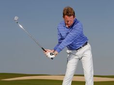 a man hitting a golf ball with a club