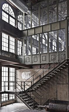 an old building with lots of windows and metal stairs leading up to the second floor