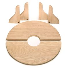 a wooden cutting board with two knives and a piece of wood on the bottom that has been cut in half