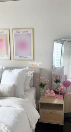 a bedroom with white bedding and pink accents