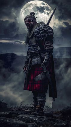 a man dressed in scottish clothing standing on rocks with a full moon in the background