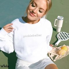 This cute embroidered pickleball sweatshirt is sure to make a pickleballer smile from ear to ear. PLEASE CHECK PHOTOS FOR SIZE AND COLOR CHART. Colour could be slightly different from photo depending on your screen & the photo lighting. If you want a baggier fit, please choose 1-2 sizes up. These shirts are UNISEX sized. Ideal for any situation, a unisex heavy blend crewneck sweatshirt is pure comfort. These garments are made from polyester and cotton. This combination helps designs come out looking fresh and beautiful. The collar is ribbed knit, so it retains its shape even after washing. There are no itchy side seams on these sweaters.  .: 50% cotton, 50% polyester .: Medium-heavy fabric (8.0 oz/yd² (271.25 g/m .: Loose fit .: Sewn-in label .: Runs true to size PLEASE check the chart in White Embroidered Logo Sweatshirt For Game Day, White Tops With Letter Embroidery For Sports Season, White Embroidered Logo Athletic Sweatshirt, White Tops With Letter Embroidery For Sports Events, White Embroidered Tops For Sports Events, White Embroidered Sporty Sweatshirt, Sporty White Tennis Sweatshirt, Casual White Sweatshirt For Tennis, Casual White Tennis Sweatshirt