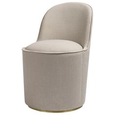 an upholstered chair with a round back and gold trim around the armrests