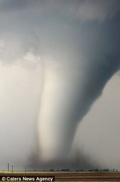 a very large tornado is in the sky