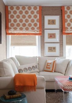 a living room with orange and white decor