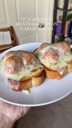 two meatball subs on garlic bread are sitting on a white plate with the title quick and easy meatball subs on garlic bread