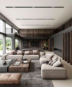 a large living room with couches, tables and windows on the side of it