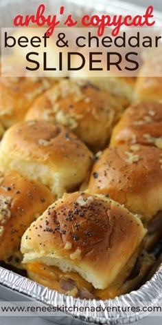 a close up of some sliders in a pan with cheese and black sesame seeds