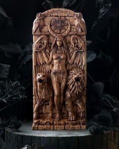 a wooden carving of an angel with two lions and a woman holding a star above her head