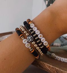 Calling all soccer mamas Customize this stack with your kiddo's name, number, and team colors  If you have more than one kiddo playing soccer, send a message! we can add more bracelets to represent all of your littles  These bracelets are made with elastic string, clay disc beads, and 14K gold filled beads Bracelets are all made 6.75" in diameter. If you need a different size, please tell me in the personalization box! Team Beaded Bracelets, Personalized Black Sporty Bracelets, Sporty Personalized Black Bracelets, Sporty Personalized Black Bracelet, Soccer Bracelets, Soccer Bracelet, Team Bracelets, Mama Bracelet, Mom Bracelet