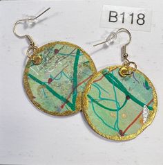 Add some unique flair to your jewelry collection with these beautiful handmade earrings by Russell and Joyce. These earrings are crafted from paper and hand-painted with a brown & Green,   design, making each pair completely one-of-a-kind. The dangle/drop style adds a touch of elegance to any outfit, and the   multi-colored color combination is perfect for adding a pop of color to your look. These earrings are lightweight and comfortable to wear all day long. With no stones, they are perfect for any occasion. See photo with front and back. Buy 2 pair and shipping is free Green Artistic Dangle Earrings, Artistic Green Earrings For Gift, Green Dangle Earrings With Artistic Design, Green Earrings With Artistic Design For Gift, Green Hand-painted Bohemian Earrings, Artsy Green Drop Earrings, Artsy Green Earrings For Gift, Artsy Green Earrings With Ear Wire, Artsy Green Earrings