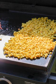 corn kernels are being cooked on the grill