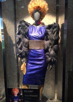 a mannequin wearing a purple dress and fur coat