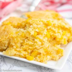 a close up of a plate of food with mashed potatoes and corn on it