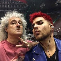 two men with red hair and piercings standing next to each other at a concert