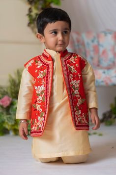 Red bundi with floral embroidery and mandarin collared neckline. Paired with beige kurta and churidar.
Component: 3
Pattern: Embroidery
Type Of Work: Floral
Neckline: Mandarin collar
Sleeve Type: Bundi: Sleeveless, Kurta: Full sleeves
Fabric: Samo Silk, Cotton Silk, Lining: Cotton
Color: Red,Beige
Other Details: 
Front open bundi
Occasion: Festive and Wedding - Aza Fashions Sleeveless Festive Set With Multicolor Embroidery, Festive Sleeveless Set With Multicolor Embroidery, Traditional Sleeveless Set With Zari Work, Sleeveless Floral Embroidered Choli For Eid, Sleeveless Floral Embroidery Choli For Eid, Sleeveless Traditional Wear With Resham Embroidery For Festive Occasions, Sleeveless Resham Embroidery Traditional Wear For Festive Occasions, Sleeveless Embroidered Traditional Wear For Festive Occasions, Festive Sleeveless Traditional Wear With Resham Embroidery