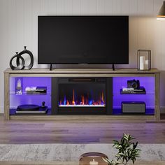 a living room with a large television and fire place in front of the flat screen tv