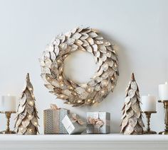 a wreath and christmas presents on a mantle