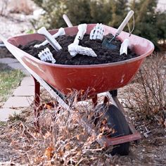 a wheelbarrow filled with dirt and shovels