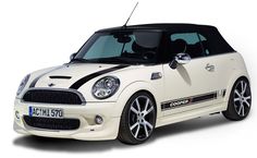 a small white car with black stripes on it's hood