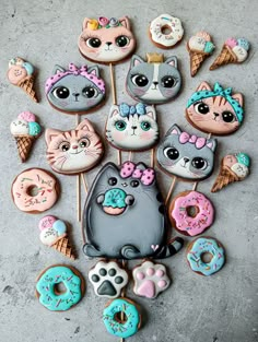 there are many decorated cookies in the shape of cats