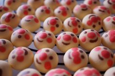 there are many decorated cookies with red noses on the top one is white and has pink icing