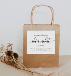 a brown paper bag sitting on top of a table next to dried flowers and a plant